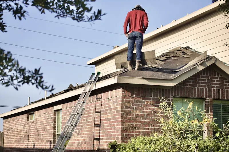 Professional roofer working on a residential roof in Swift